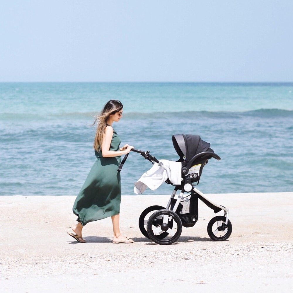 Photo of Natalie Kay of Sustainably Chic with her Bumbleride Speed jogging stroller and Nuna Car Seat with Bumbleride Indie Car Seat Adapter Attached