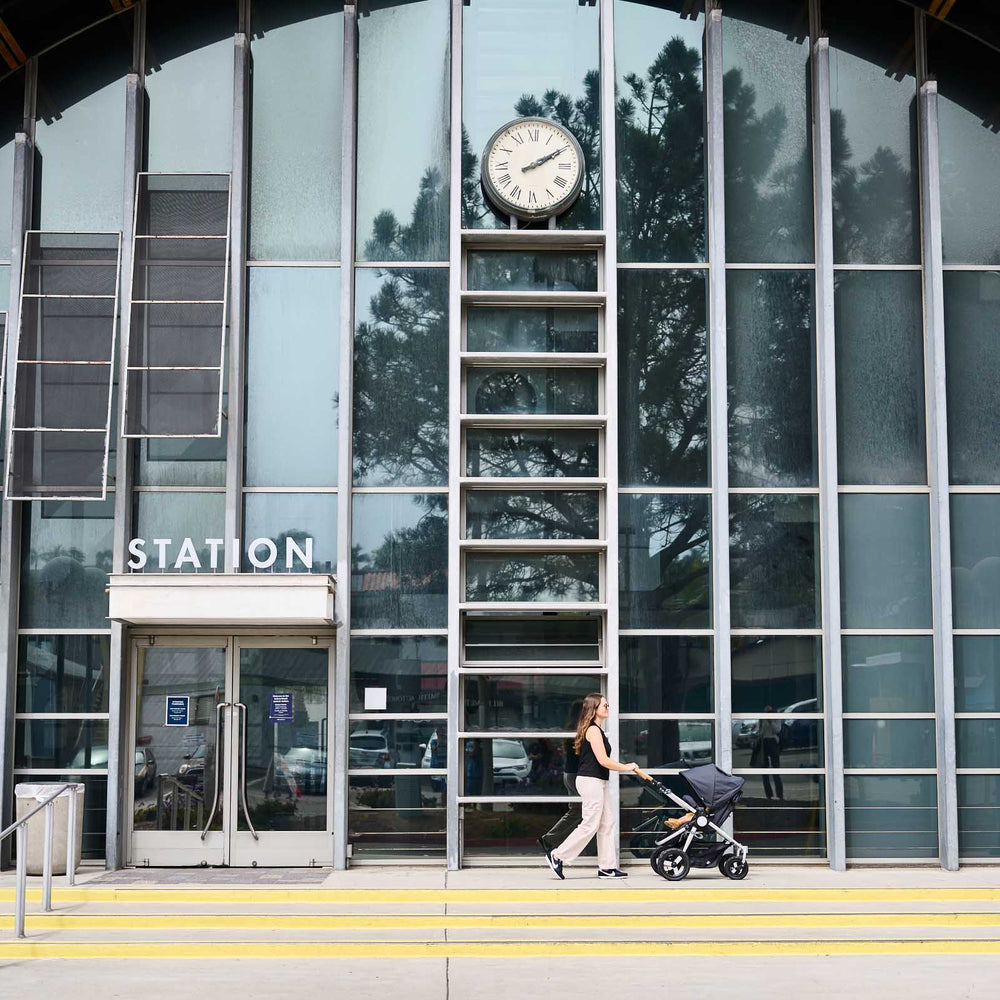 
                  
                    Picture of mother pushing Bumbleride Era reversible stroller in front of train station. New Collection 2022- Global
                  
                