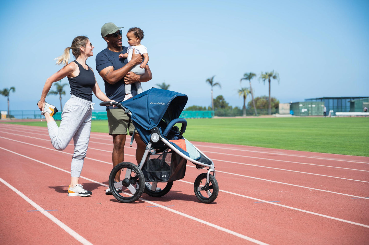 Picture of family getting ready to run on soft running track with Bumbleride Speed jogging stroller in Supernova. New Collection 2022. Global
