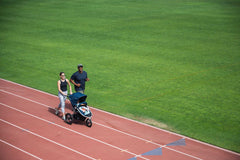 Picture of family starting their run on soft running track with Bumbleride Speed jogging stroller in Supernova. New Collection 2022. Global