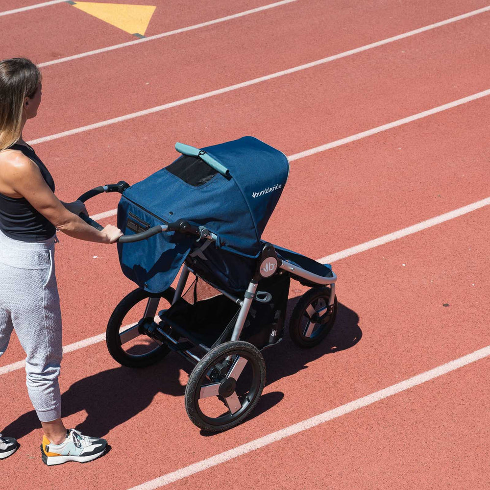 
                      
                        Picture of mother getting ready to run on soft running track with Bumbleride Speed jogging stroller in Supernova. New Collection 2022. Global
                      
                    